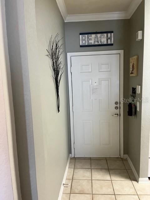An entryway features a white door, tiled flooring, and a beach-themed wall sign — 1216 S MISSOURI AVENUE UNIT 228, CLEARWATER, FL