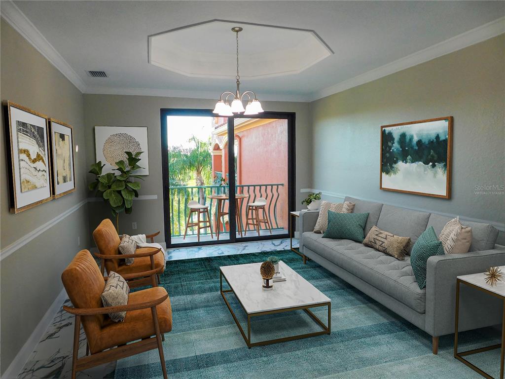 A living room features a gray sofa, two leather armchairs, a coffee table, and a balcony — 2725 VIA CIPRIANI UNIT 735B, CLEARWATER, FL
