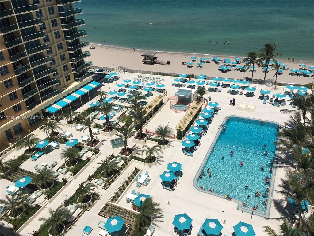 An aerial view shows a swimming pool, lounge chairs with umbrellas, and a beach — 2501 S OCEAN DR, Hollywood FL 33019, HOLLYWOOD, FL