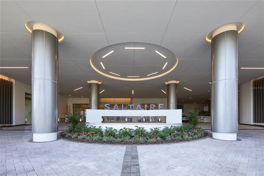 The entrance to the Saltaire building features a circular driveway, large metallic columns, and landscaping — 301 1ST STREET S UNIT 804, ST PETERSBURG, FL