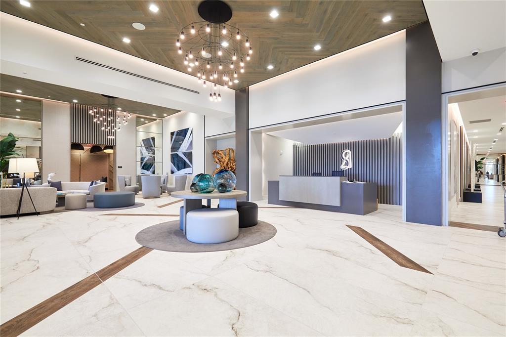 A modern lobby features a reception desk, lounge seating, and a herringbone wood ceiling — 301 1ST STREET S UNIT 804, ST PETERSBURG, FL
