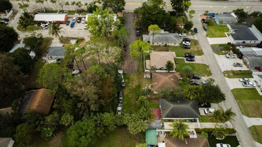 An aerial view shows a narrow, undeveloped lot situated between several residential properties and streets — 3630 S Haverhill Road, FL 33463, FL