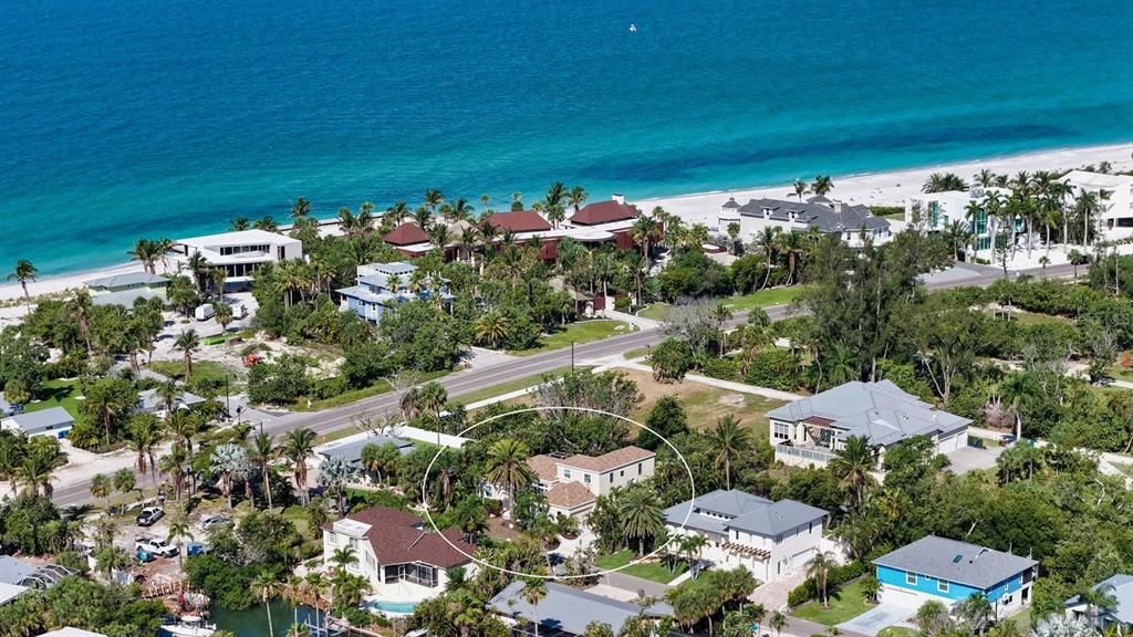 An aerial view shows a house circled in white surrounded by lush vegetation and homes — 523 JUAN ANASCO DRIVE, LONGBOAT KEY, FL