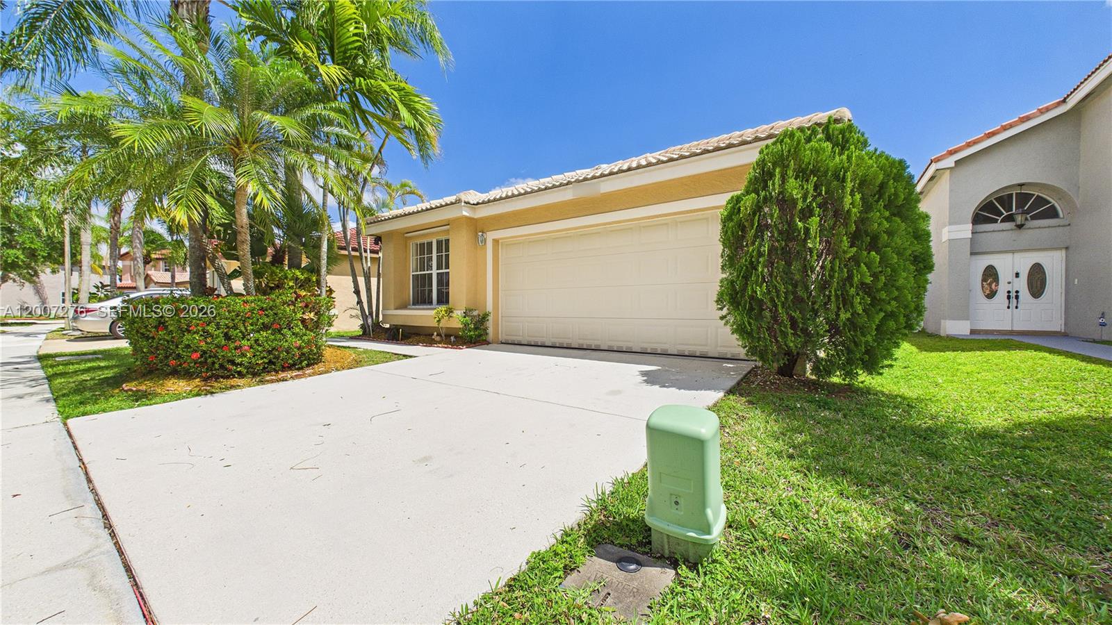 A single-story house with a beige exterior, a two-car garage, and a manicured front lawn — 17626 SW 20th St, Miramar FL 33029, MIRAMAR, FL