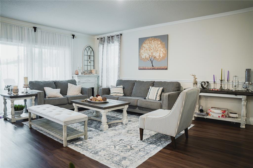 A living room features gray sofas, a coffee table, a striped chair, and a rug — 2907 SUMMER GREEN TRAIL, KISSIMMEE, FL