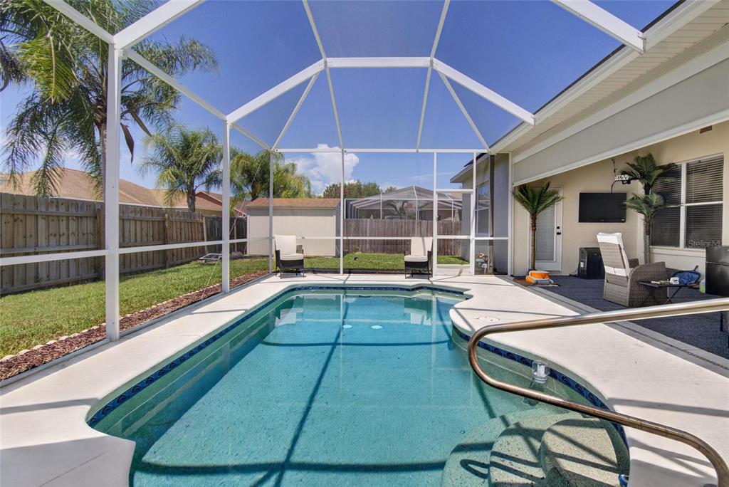 A screened-in swimming pool with a patio area and a fenced backyard — 11937 TIMBERHILL DRIVE, RIVERVIEW, FL