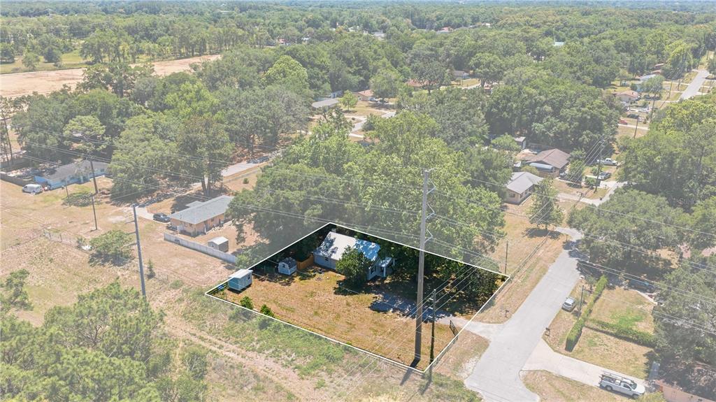 An aerial view shows a single-story house on a large, grassy lot with trees — 3017 NE 24TH COURT, OCALA, FL