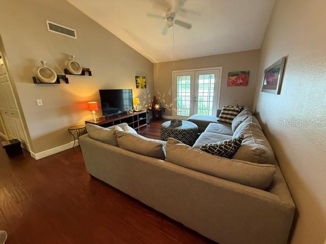 A living room features a large sectional sofa, a television, and a ceiling fan — 145 N PEARL LAKE CAUSEWAY UNIT 210, ALTAMONTE SPRINGS, FL