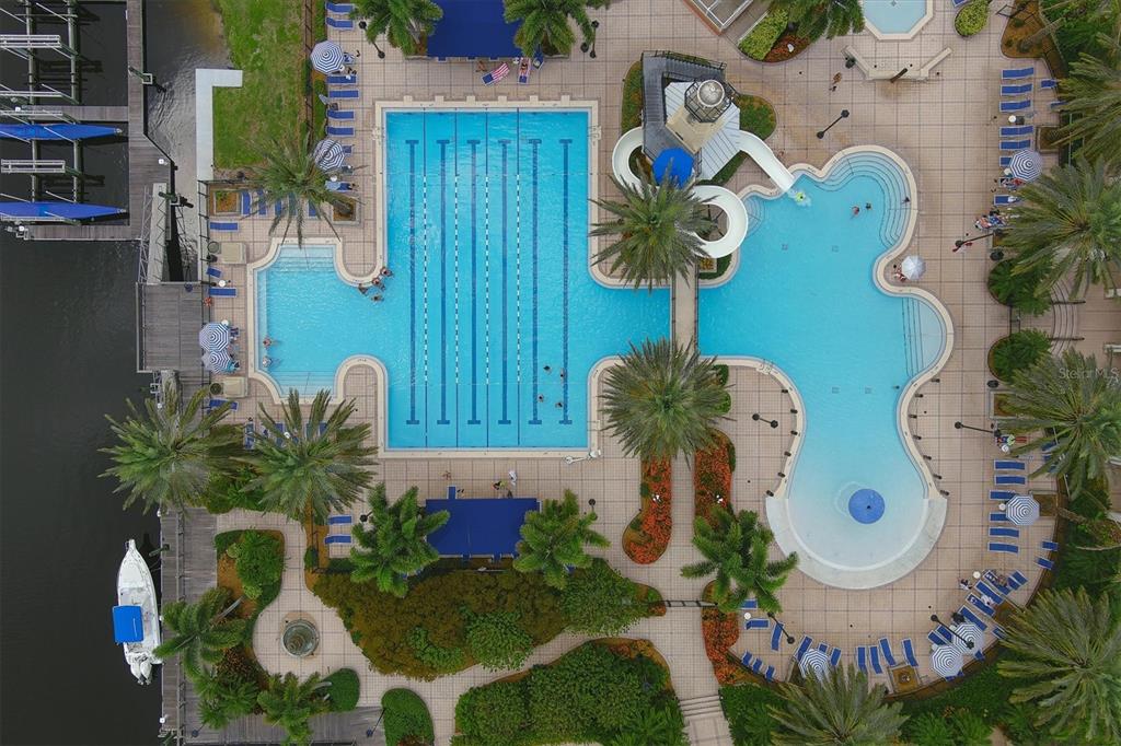 An aerial view shows a large swimming pool complex with a waterslide and lounge chairs — 724 WINTERSIDE DRIVE, APOLLO BEACH, FL