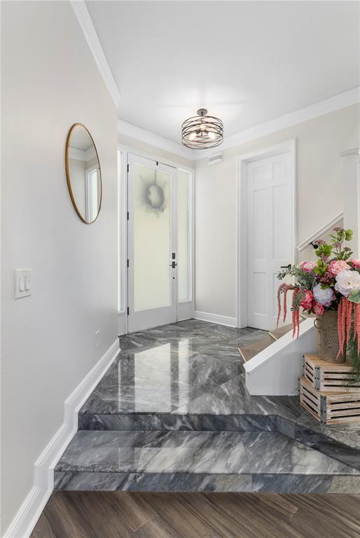 An entryway features a marble-tiled landing, a white front door, and a decorative light fixture — 8455 FOXWORTH CIRCLE UNIT 3, ORLANDO, FL