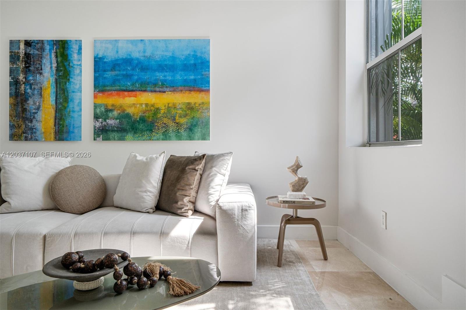 A modern living room features a white sofa, abstract wall art, and a small side table — 21156 NE 33rd Ave, Aventura FL 33180, AVENTURA, FL
