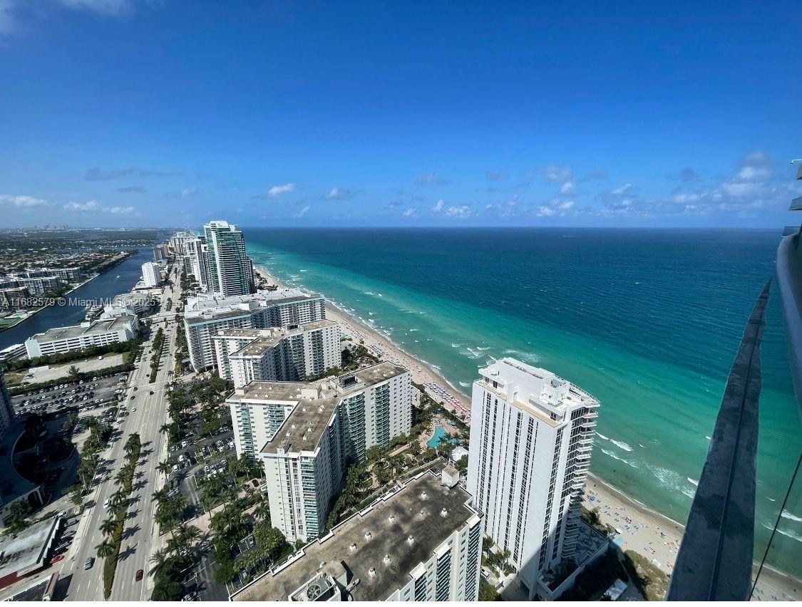 An elevated view of a coastal city skyline featuring high-rise buildings along a sandy beach — 4111 S Ocean Dr # 2712, Hollywood FL 33019, HOLLYWOOD, FL