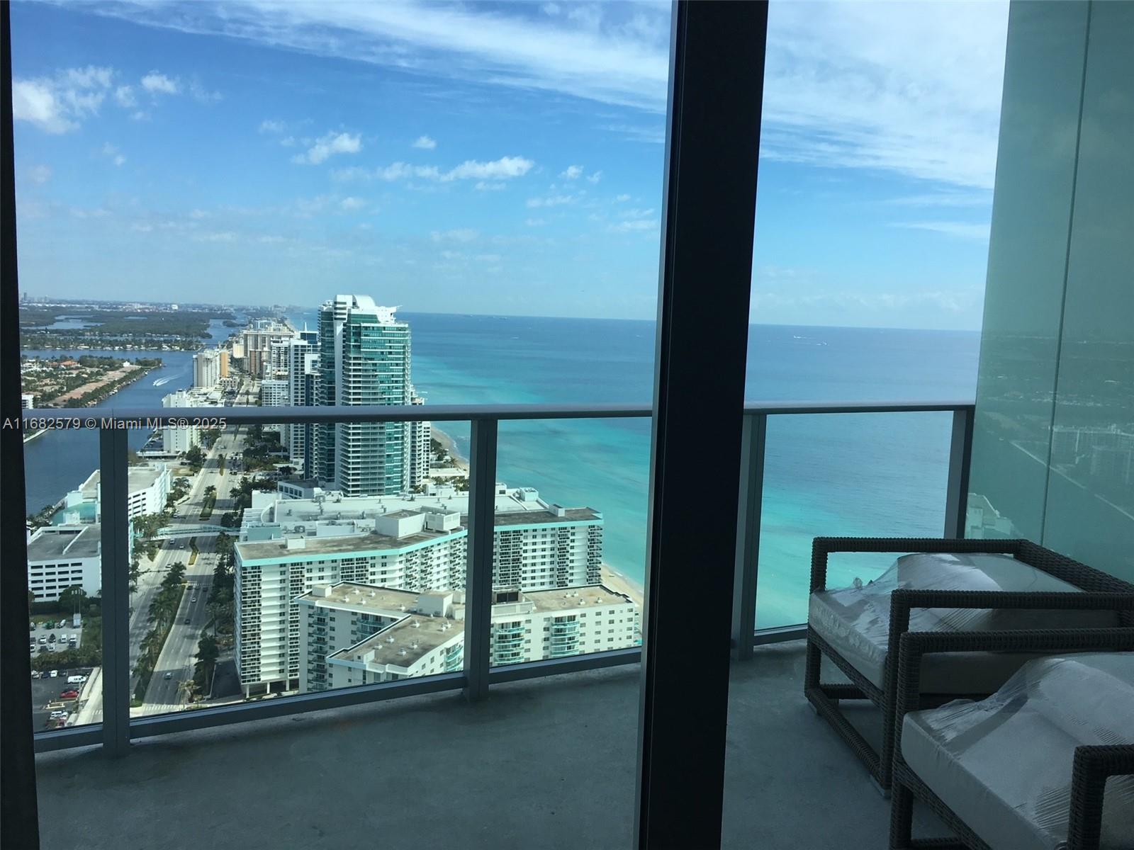 A high-rise balcony overlooks a coastal city skyline and the ocean — 4111 S Ocean Dr # 2712, Hollywood FL 33019, HOLLYWOOD, FL