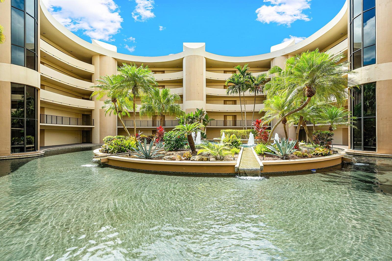 A circular courtyard features a central landscaped island with palm trees and a water fountain — 1401 S Ocean Boulevard # 1050, Boca Raton FL 33432, BOCA RATON, FL