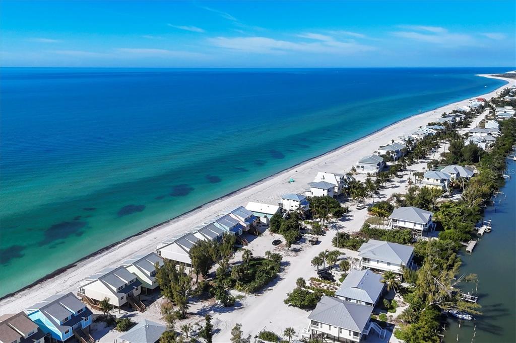 An aerial view of beach houses situated between the ocean and a narrow waterway — 301 S GULF BOULEVARD UNIT 10, PLACIDA, FL