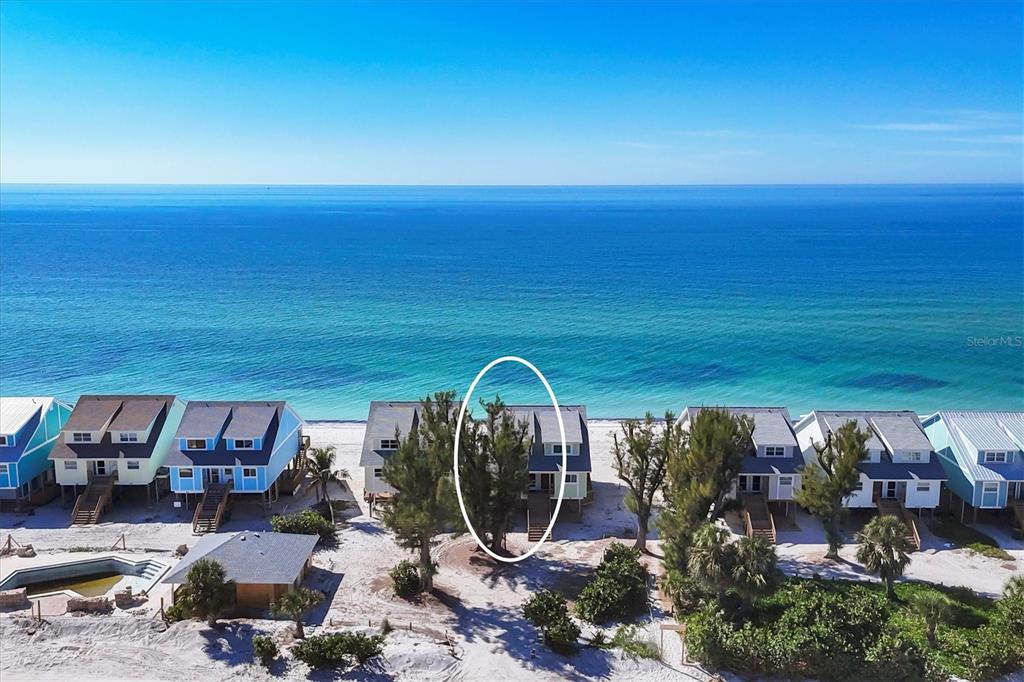 An aerial view shows a row of beachfront houses with a circled tree in front — 301 S GULF BOULEVARD UNIT 10, PLACIDA, FL