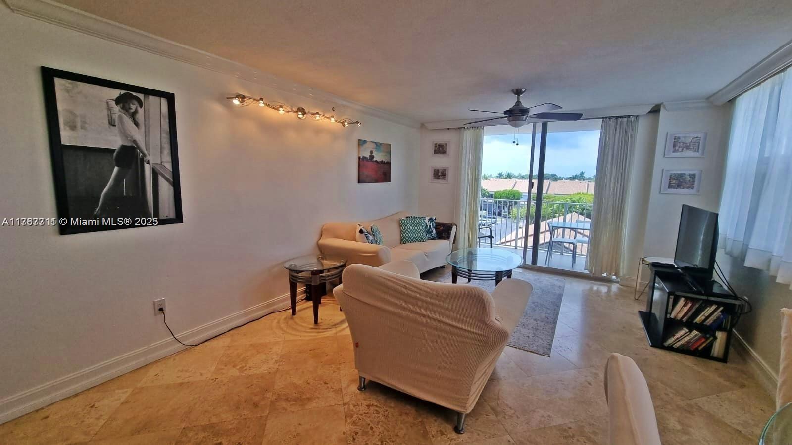A living room features light tile floors, a ceiling fan, and a sliding door to a balcony — 3594 S Ocean Blvd # 402, Highland Beach FL 33487, HIGHLAND BEACH, FL