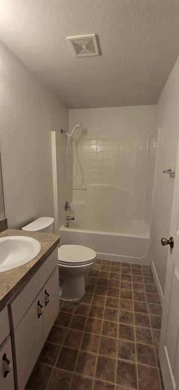 A bathroom featuring a vanity, a toilet, and a shower-tub combination with tiled flooring — 6875 SE 52ND STREET, OCALA, FL