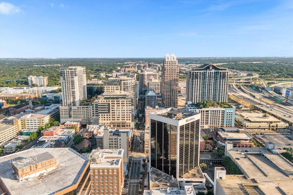 An aerial view of a dense city skyline featuring high-rise buildings and a highway interchange — 189 S ORANGE AVENUE UNIT 1550-1570, ORLANDO, FL