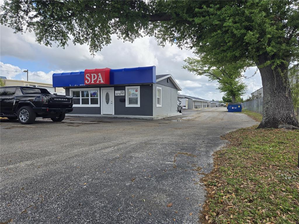 A small gray building with a blue awning labeled SPA sits next to a black truck — 11151 66TH STREET, LARGO, FL