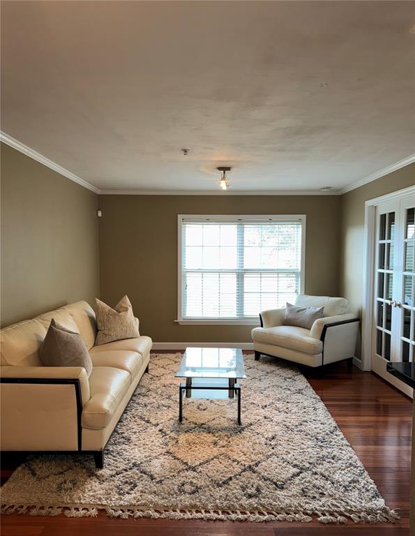 A living room features a beige sofa, an armchair, a glass coffee table, and a rug — 2053 DIXIE BELLE DRIVE UNIT 2053P, ORLANDO, FL