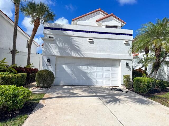 A white two-story house with a tile roof and two cars parked in the driveway — 5544 Fox Hollow Drive, Boca Raton FL 33486, BOCA RATON, FL