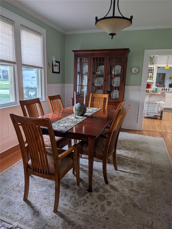 A dining room features a wooden table and chairs, a hutch, and light green walls — 410 E PARK STREET, LAKELAND, FL