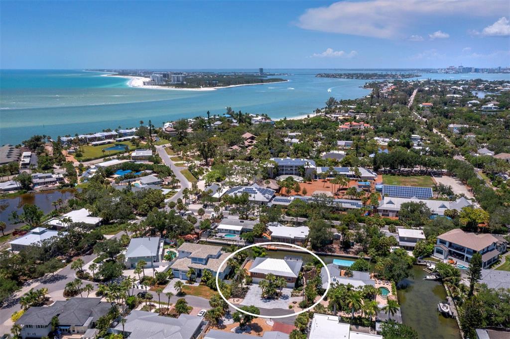 An aerial view shows a residential house with a metal roof circled in a neighborhood — 521 CUMMINGS STREET, SARASOTA, FL