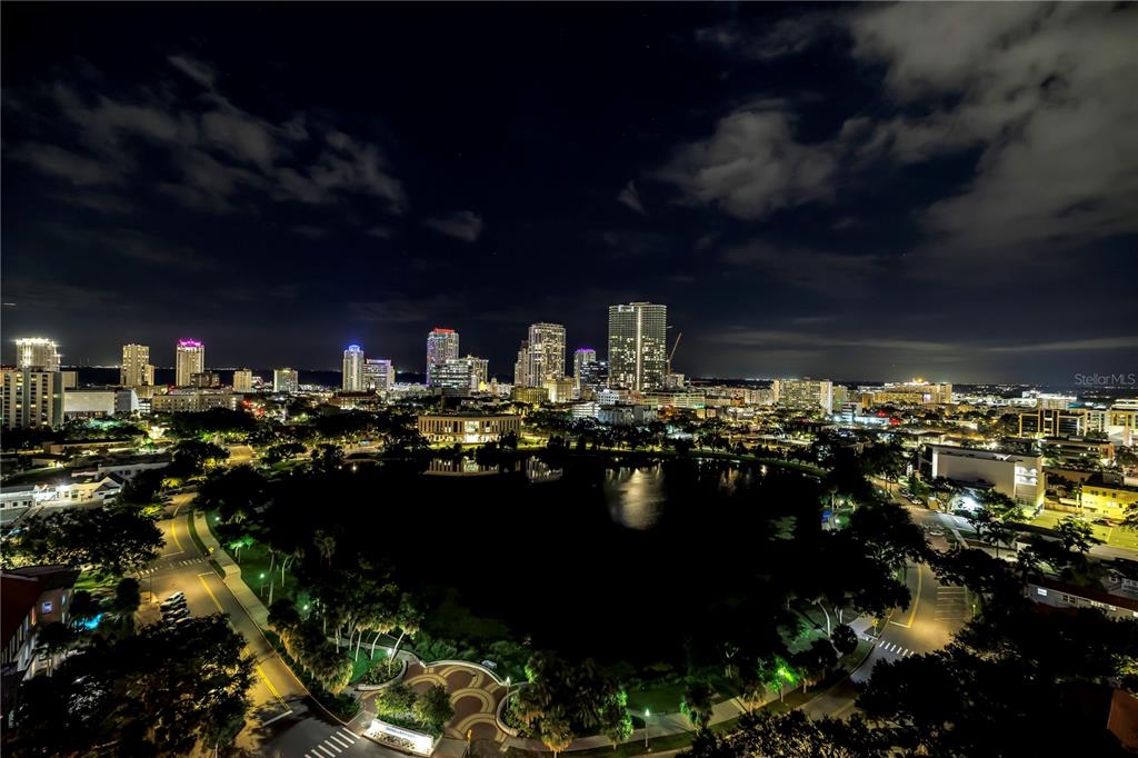 An elevated night view of a city skyline overlooking a dark lake and park — 777 3RD AVENUE N UNIT 1605, ST PETERSBURG, FL
