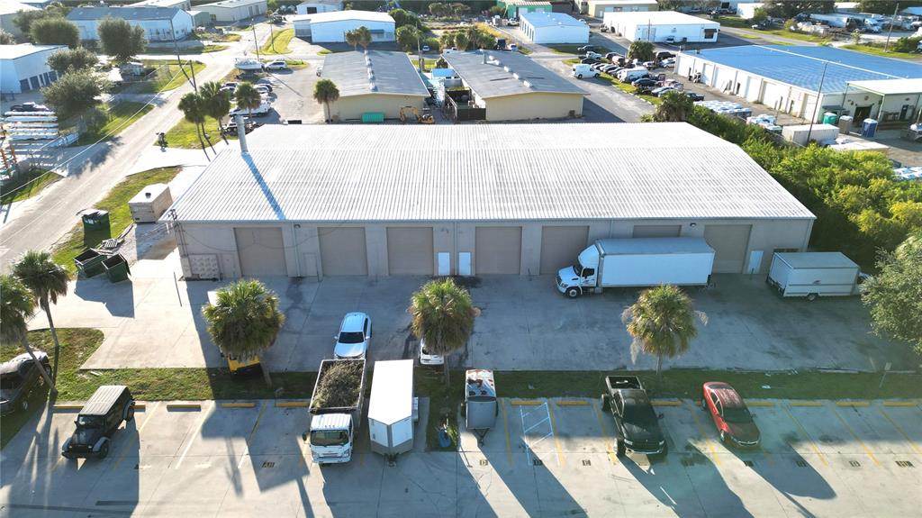 An aerial view shows a commercial warehouse building with multiple roll-up doors and parking — 4240 JAMES STREET UNIT 10,11,12,13,14, PUNTA GORDA, FL