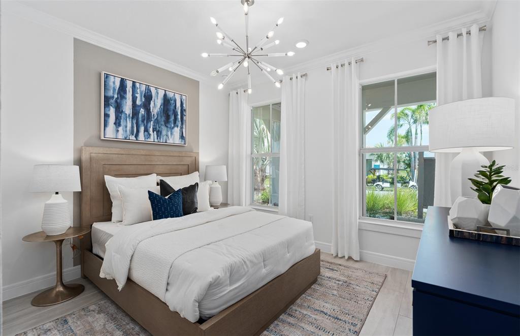 A bedroom features a queen bed, a modern sputnik chandelier, and two windows with curtains — 6807 SUNRISE COVE DRIVE, CLERMONT, FL