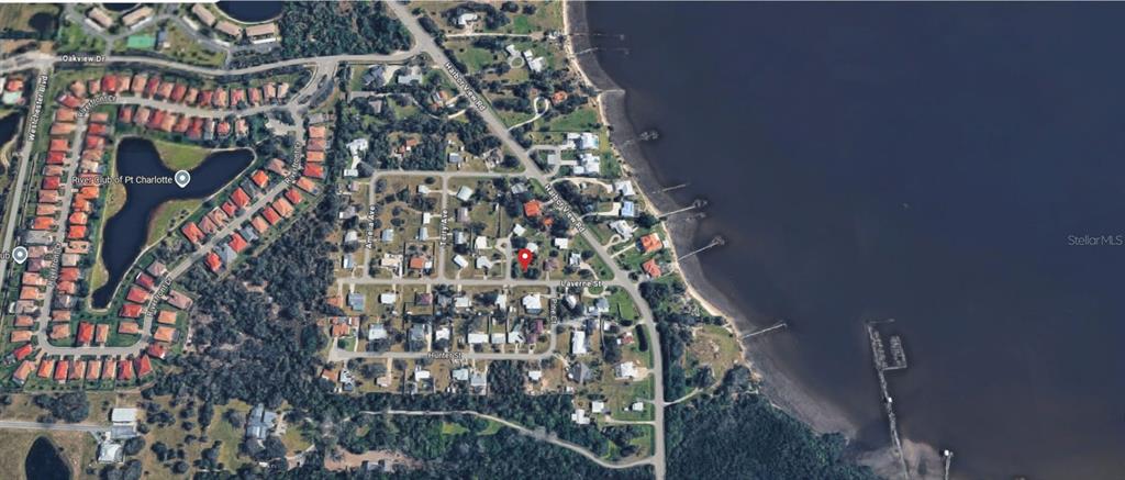 This is an aerial map view of a residential neighborhood located along a waterfront — 215 LAVERNE STREET, PUNTA GORDA, FL
