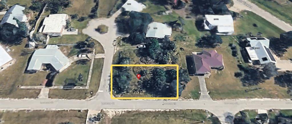 This is an aerial view of a vacant, tree-covered residential lot outlined in yellow — 215 LAVERNE STREET, PUNTA GORDA, FL
