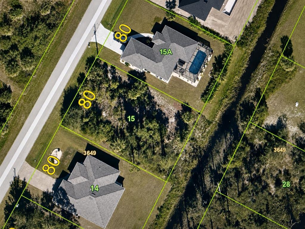 This aerial map shows a vacant residential lot situated between two houses with swimming pools — 7132 QUARRY STREET, ENGLEWOOD, FL