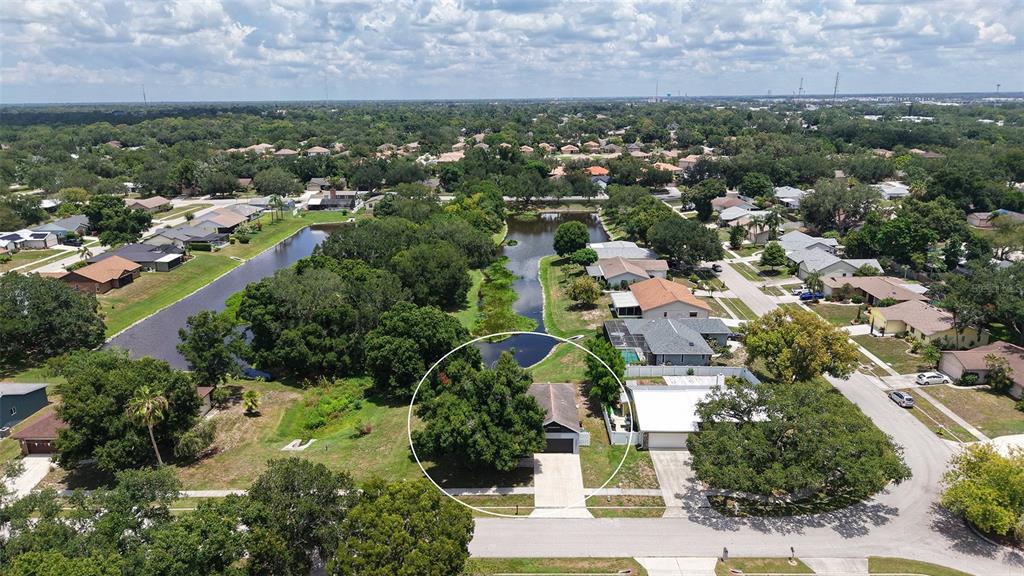 An aerial view shows a single-story house with a large tree in the front yard — 2481 S SCARLET OAK COURT, SARASOTA, FL