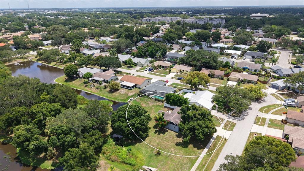An aerial view shows a single-story house with a large yard and surrounding trees — 2481 S SCARLET OAK COURT, SARASOTA, FL