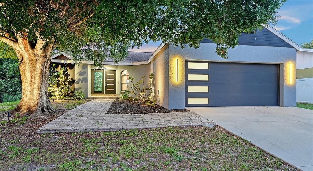 A single-story house with a blue garage, a paved walkway, and a large tree — 2481 S SCARLET OAK COURT, SARASOTA, FL