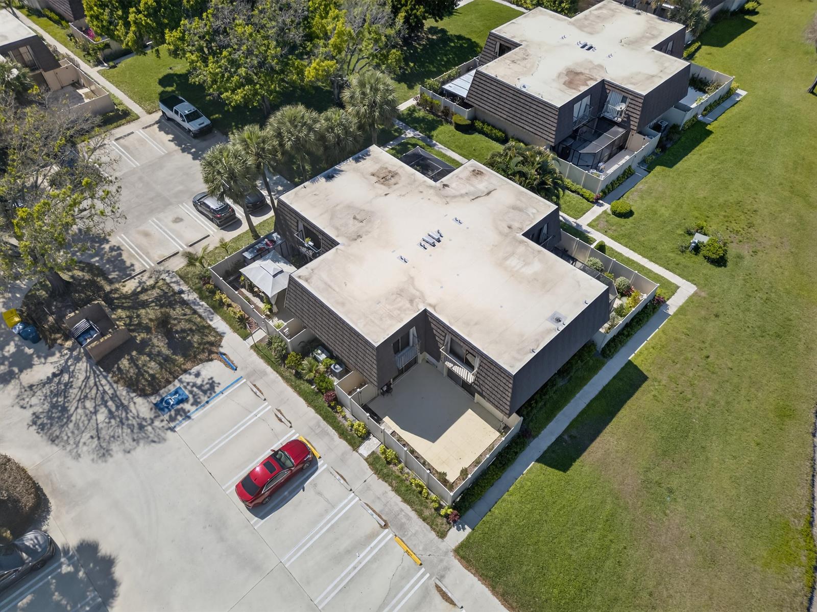 An aerial view shows a multi-unit residential building with flat roofs and adjacent parking lots — 7811 78th Way, West Palm Beach FL 33407, WEST PALM BEACH, FL