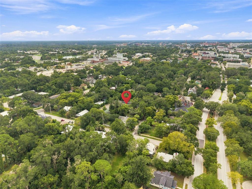 An aerial view shows a residential neighborhood with a red pin marking a specific property — 747 SE 2ND PLACE UNIT 2, GAINESVILLE, FL