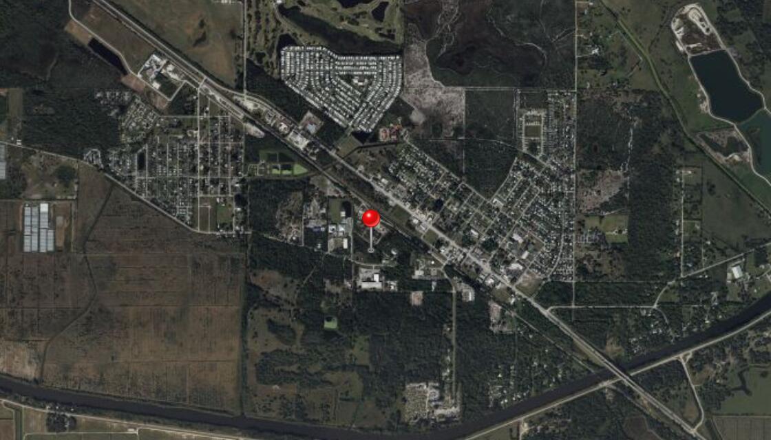 This is an aerial map view showing a red location pin over a suburban area — 0 SW Carrier Street, FL 34956, FL