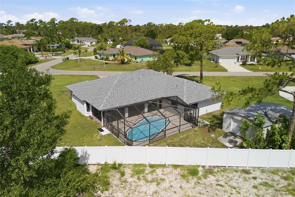 An aerial view shows a house with a screened-in pool and a detached garage — 5412 ULYSSES STREET, PORT CHARLOTTE, FL