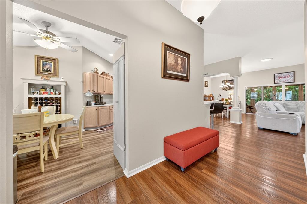 A view from a hallway looking into a dining area and a living room — 16767 SE 77TH NORTHRIDGE COURT, THE VILLAGES, FL