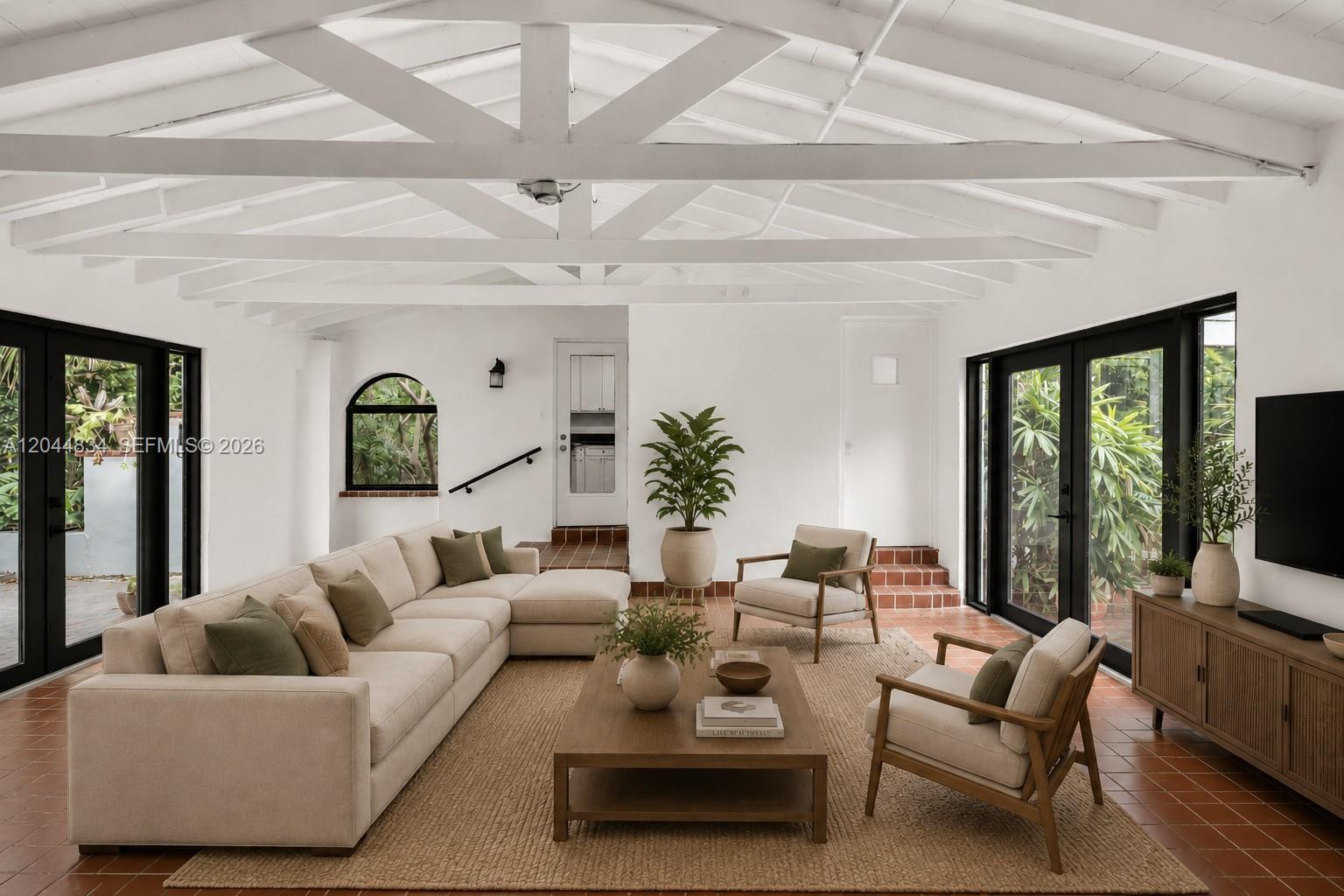 A living room features white vaulted ceilings, a beige sectional, two armchairs, and terracotta flooring — 5390 Sunset Dr, Miami FL 33143, MIAMI, FL