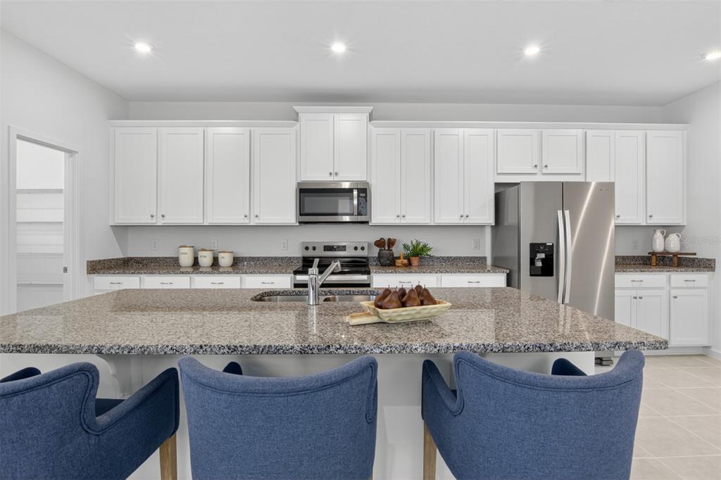 This is a floor plan of a home's main level featuring a garage, kitchen, and porch — 13685 SEAGRASS AVENUE, ORLANDO, FL