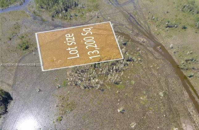 An aerial view shows a rectangular plot of land highlighted in a vast, undeveloped wetland area — 36xx SW 159th Court, Miami FL 33185, MIAMI, FL