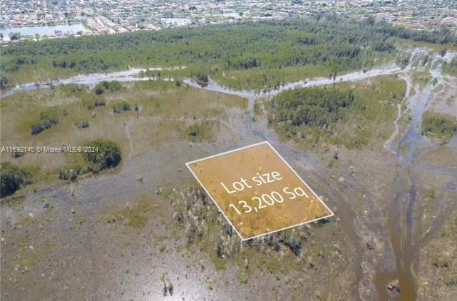 An aerial view shows a rectangular plot of land highlighted within a large, marshy area — 36xx SW 159th Court, Miami FL 33185, MIAMI, FL