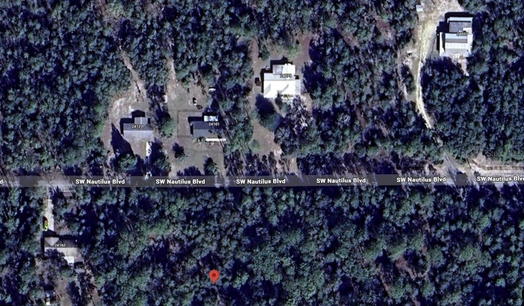 This aerial map view shows several houses situated along a wooded road — SW NAUTILUS BLVD, DUNNELLON, FL