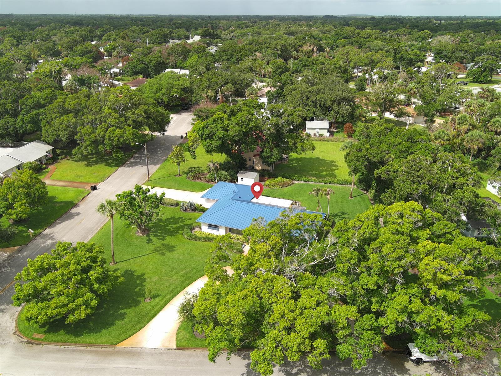 An aerial view shows a single-story house with a blue metal roof and large yard — 2301 Avalon Avenue, Vero Beach FL 32960, VERO BEACH, FL