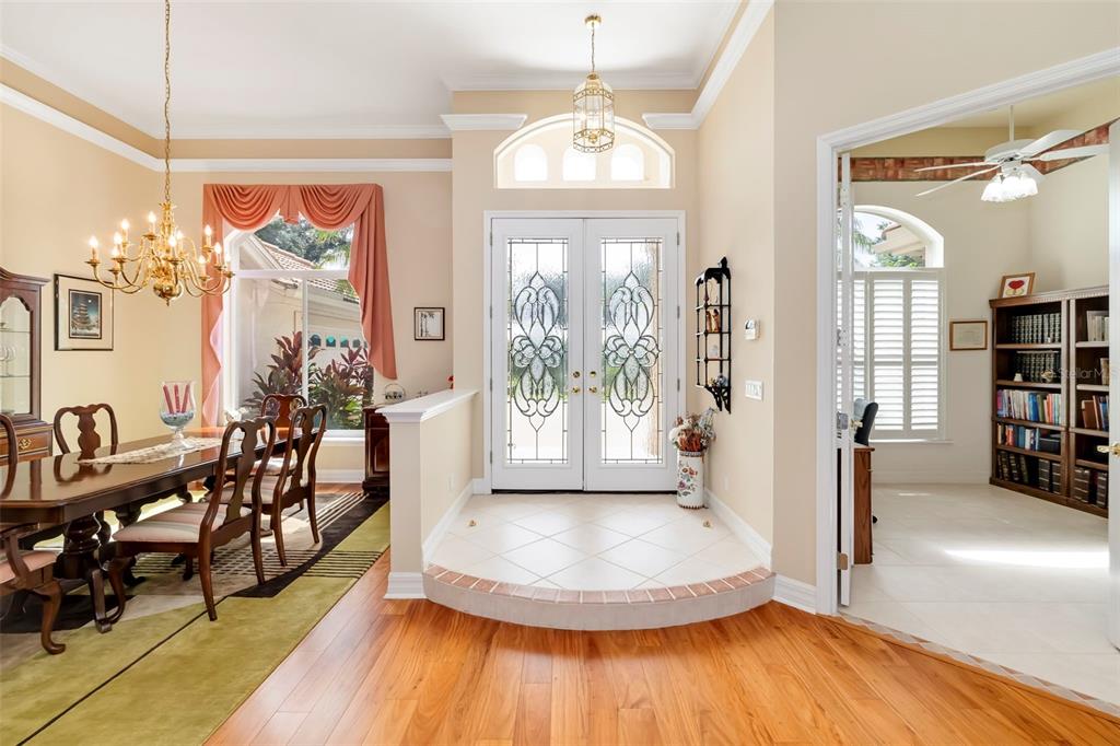 A foyer with a tiled landing and double front doors opens to a dining room — 2528 TOM MORRIS DRIVE, SARASOTA, FL