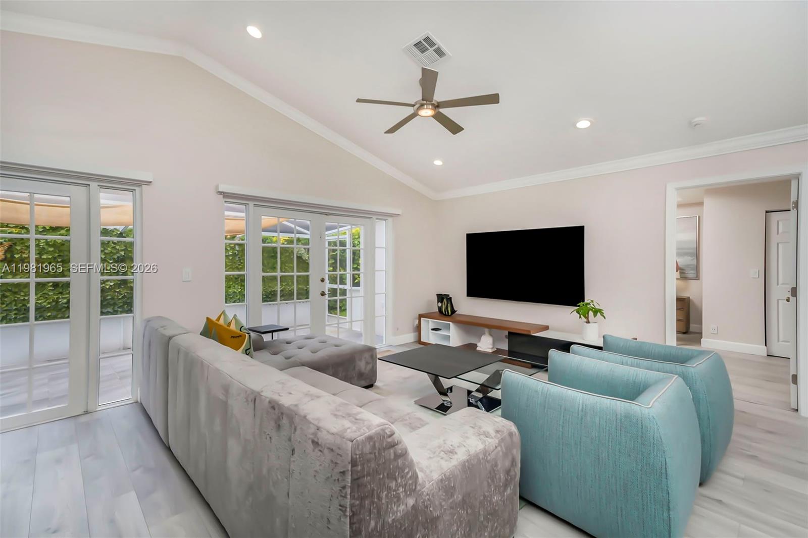 A living room features a vaulted ceiling, a large sectional, two armchairs, and glass doors — 11030 Harbour Springs Cir, Boca Raton FL 33428, BOCA RATON, FL